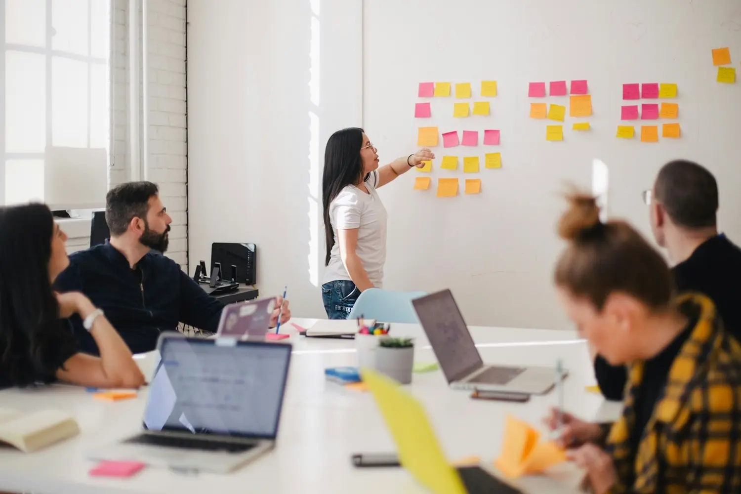 Professionelle Dame erklärt auf Whiteboard von Konzept Consulting Unternehmensberatung